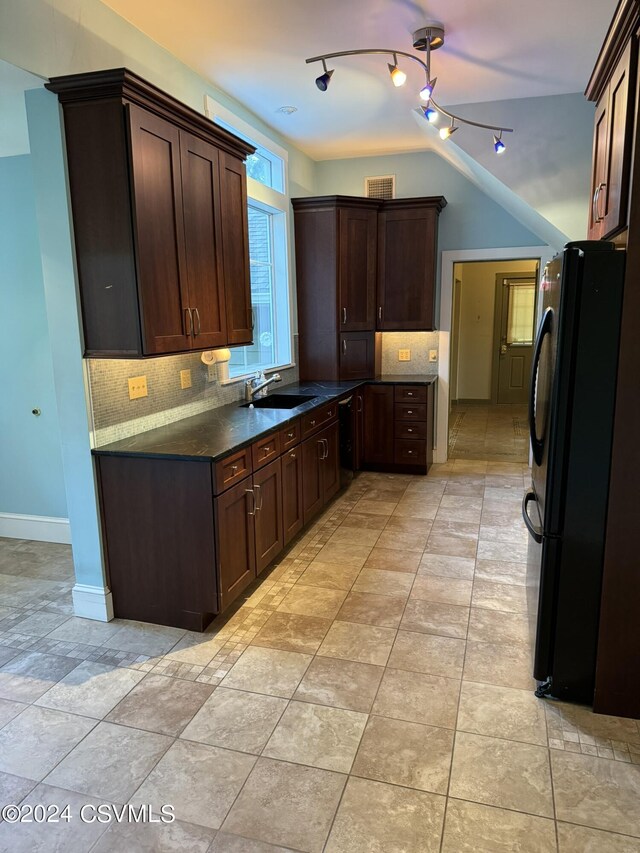 kitchen featuring dark brown cabinets, tasteful backsplash, black appliances, and sink