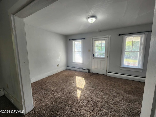 carpeted spare room featuring a baseboard radiator