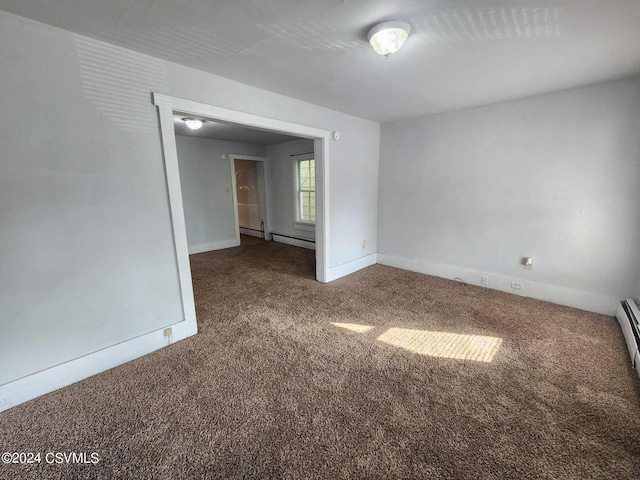 unfurnished room with a baseboard radiator and carpet