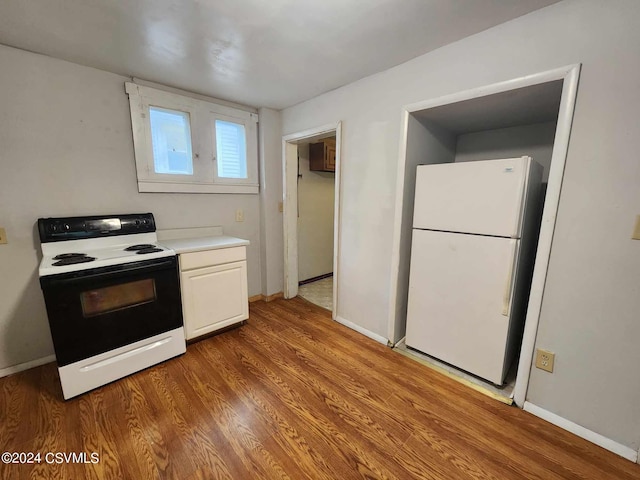 kitchen featuring white appliances and wood-type flooring