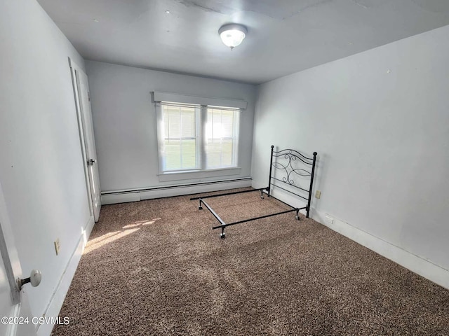 carpeted spare room with a baseboard radiator