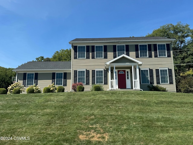 colonial home with a front lawn