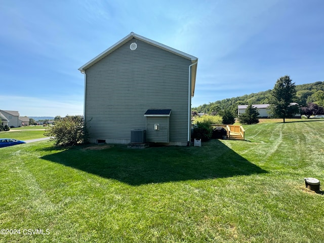 view of home's exterior featuring central AC and a lawn