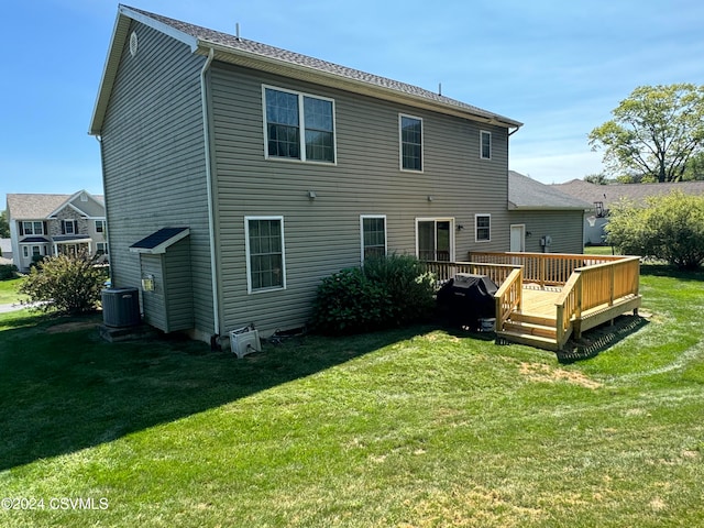 back of house featuring a yard, a deck, and central air condition unit