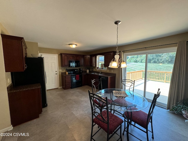 dining area featuring sink and a chandelier