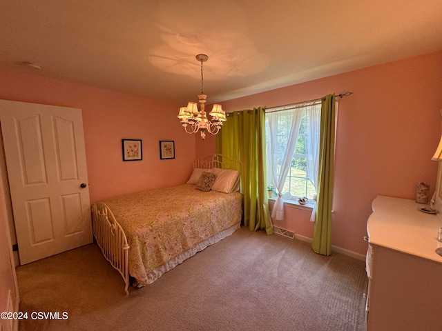 bedroom featuring carpet and a chandelier