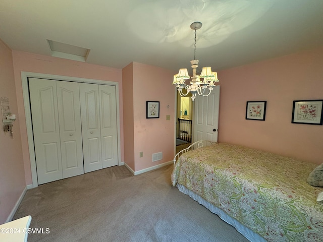 bedroom with a closet, carpet flooring, and a notable chandelier