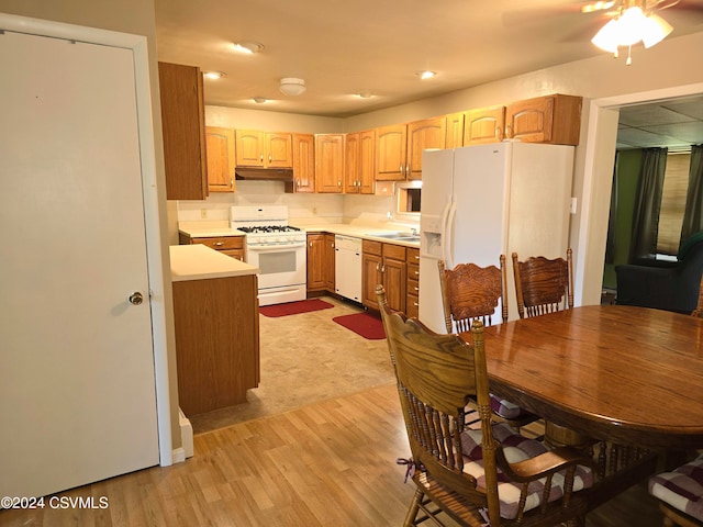 kitchen with ceiling fan, light wood-type flooring, sink, and white appliances