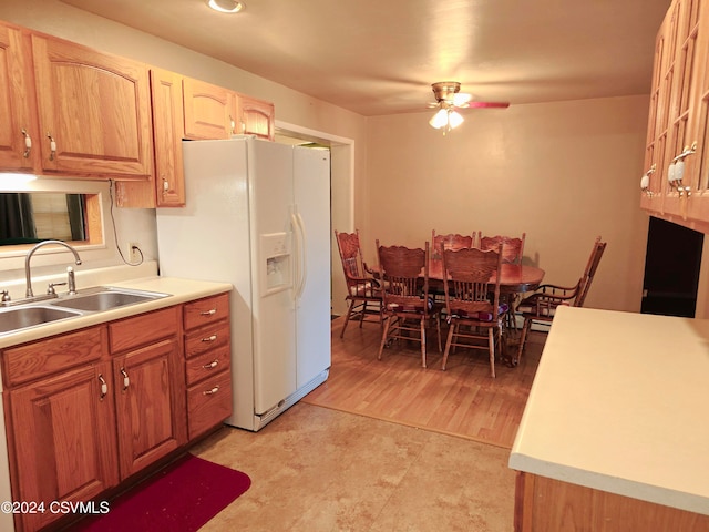 kitchen with light hardwood / wood-style flooring, white fridge with ice dispenser, sink, and ceiling fan