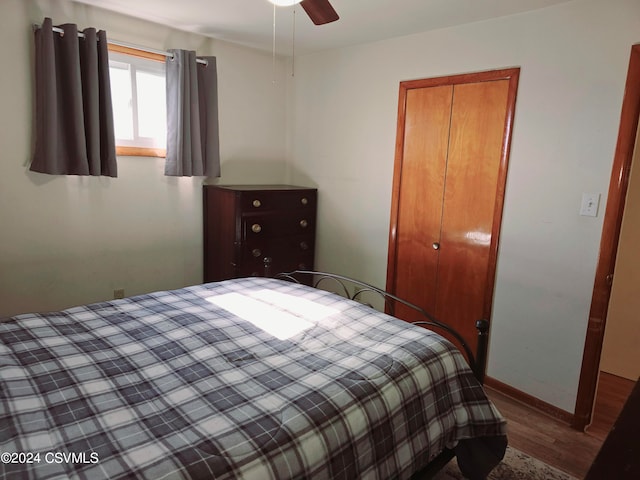 bedroom featuring hardwood / wood-style floors, ceiling fan, and a closet