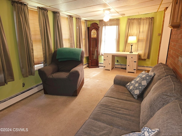 carpeted living room with baseboard heating and a drop ceiling