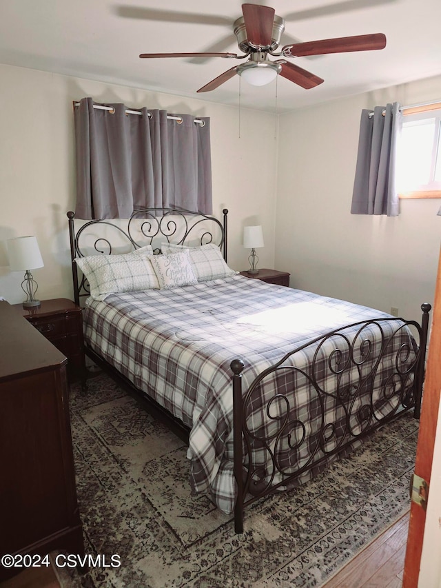 bedroom with wood-type flooring and ceiling fan