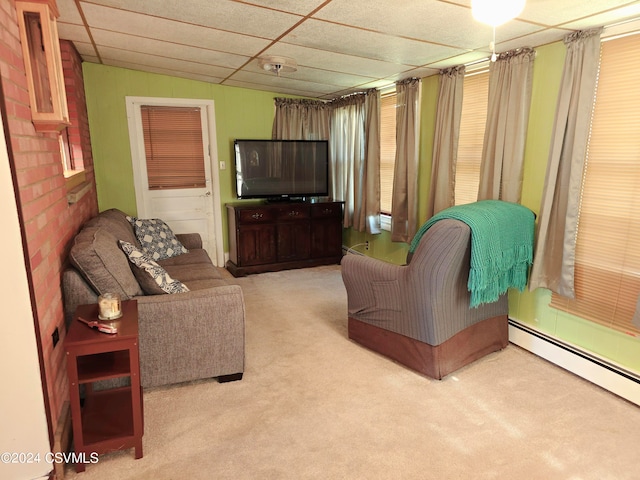 living room featuring baseboard heating, a paneled ceiling, and carpet floors