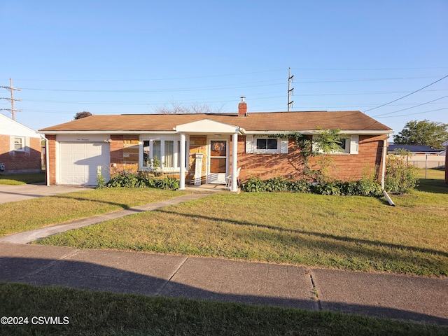 single story home featuring a garage and a front lawn