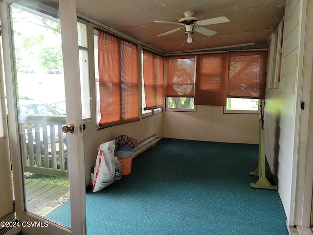 unfurnished sunroom with ceiling fan and a healthy amount of sunlight