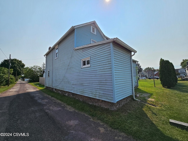 view of property exterior featuring a yard