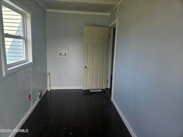 hallway featuring crown molding and dark hardwood / wood-style floors