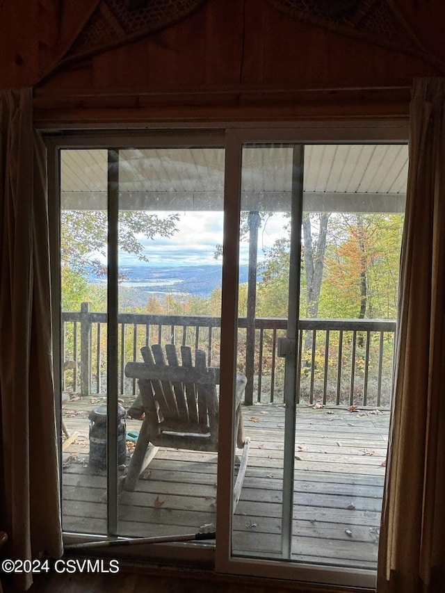 doorway to outside featuring wooden walls