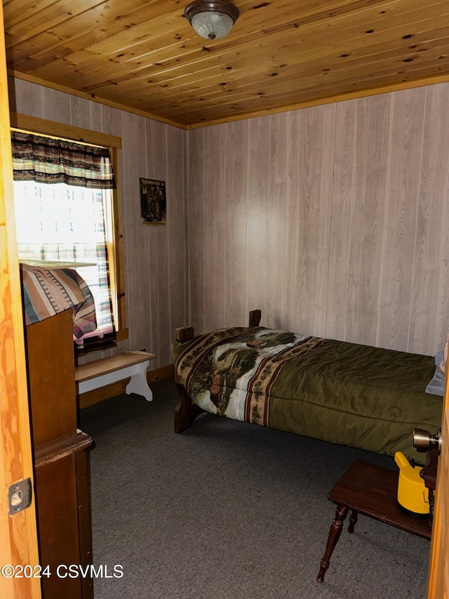 bedroom with wood walls, carpet, and wooden ceiling