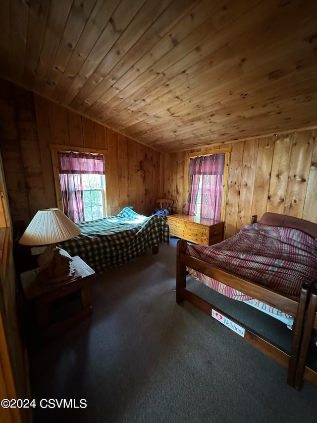 carpeted bedroom featuring wood walls, wooden ceiling, and vaulted ceiling