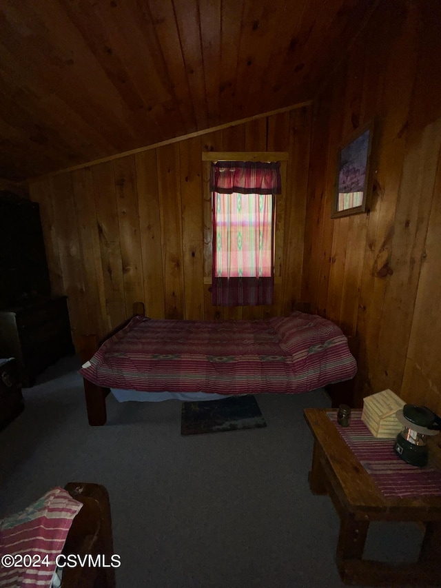 bedroom featuring wooden walls, vaulted ceiling, and wood ceiling