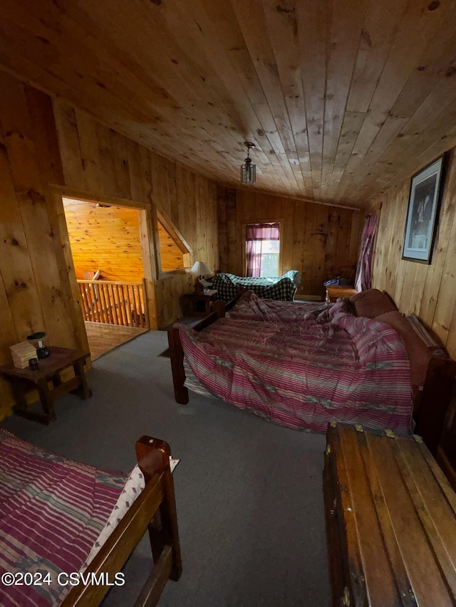 bedroom with carpet, wooden walls, and wood ceiling