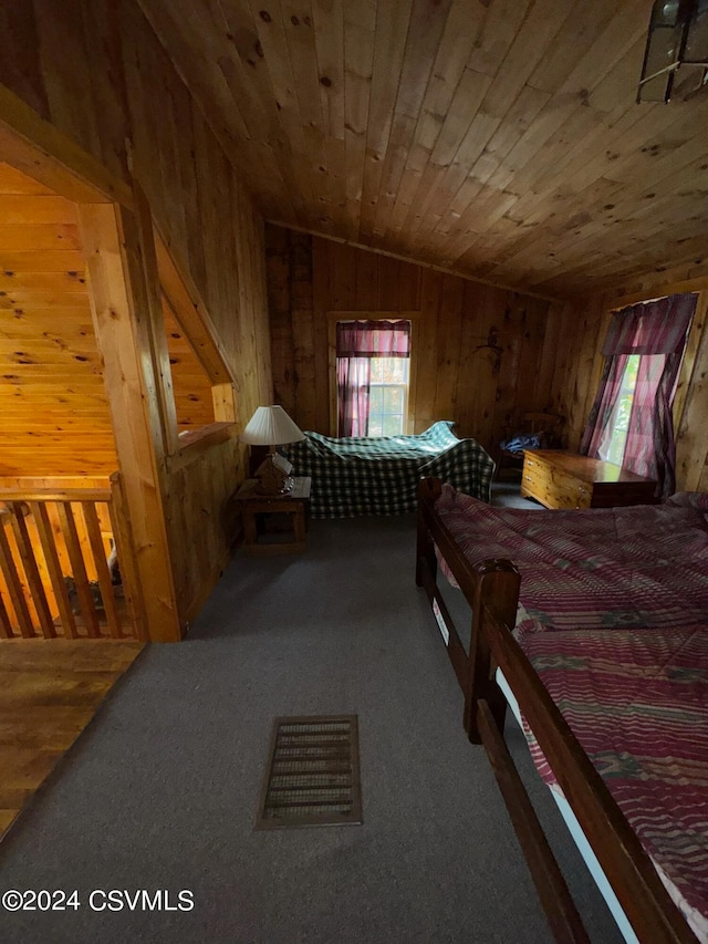 bedroom featuring carpet floors, wood walls, vaulted ceiling, and wood ceiling