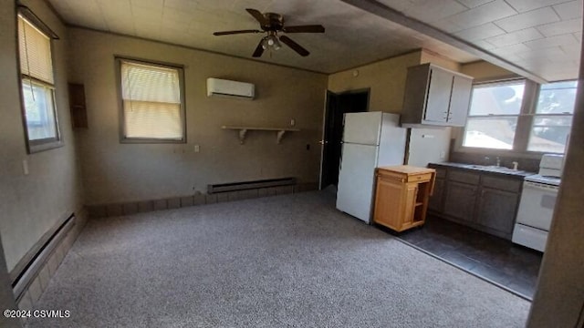 kitchen featuring dark carpet, an AC wall unit, white appliances, baseboard heating, and ceiling fan