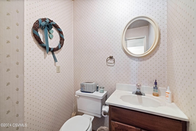 bathroom featuring vanity and toilet