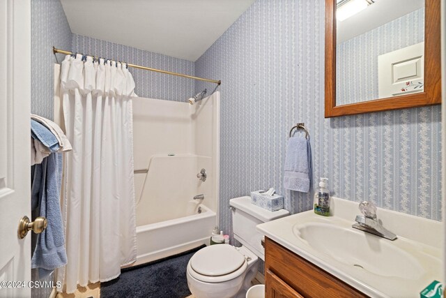 full bathroom featuring shower / bath combo, vanity, and toilet