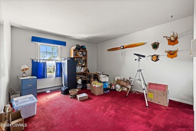 misc room with dark colored carpet and a baseboard heating unit