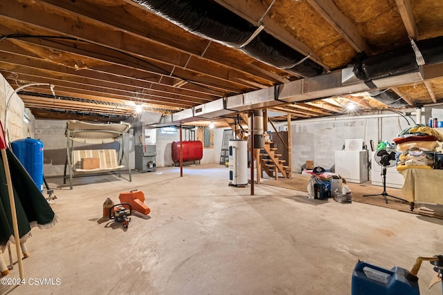 basement with washer and clothes dryer, heating unit, and water heater