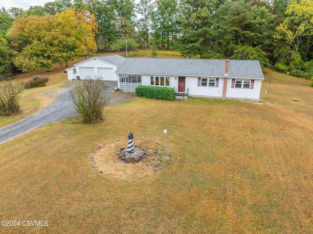 view of front of home with a garage and a front lawn