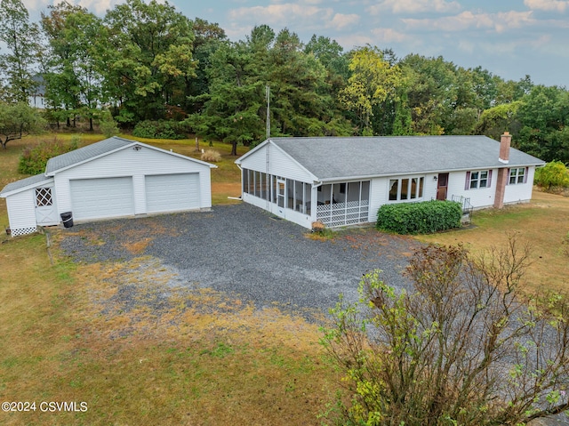 view of front of home featuring covered porch, an outdoor structure, and a garage