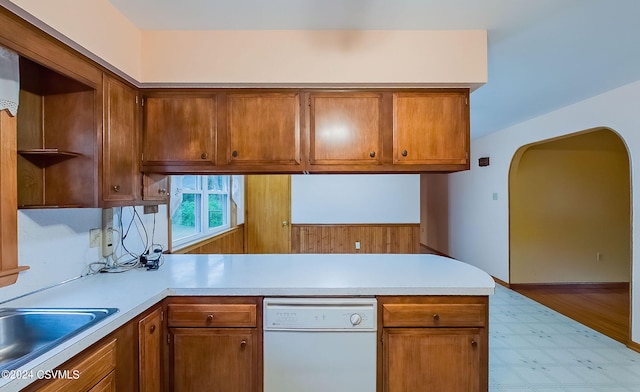 kitchen featuring sink, light hardwood / wood-style floors, kitchen peninsula, and white dishwasher