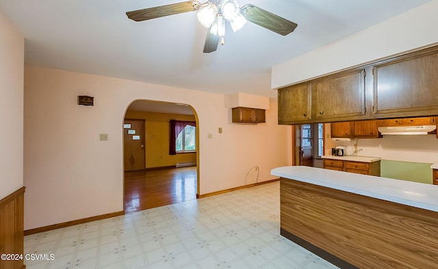 kitchen featuring a baseboard heating unit and ceiling fan