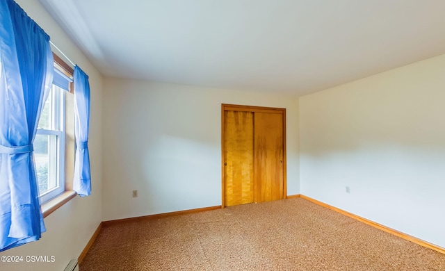 carpeted spare room featuring a wealth of natural light