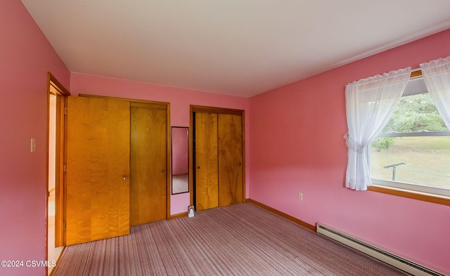 unfurnished bedroom with a baseboard heating unit and light colored carpet