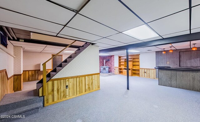 basement featuring wood walls and carpet flooring