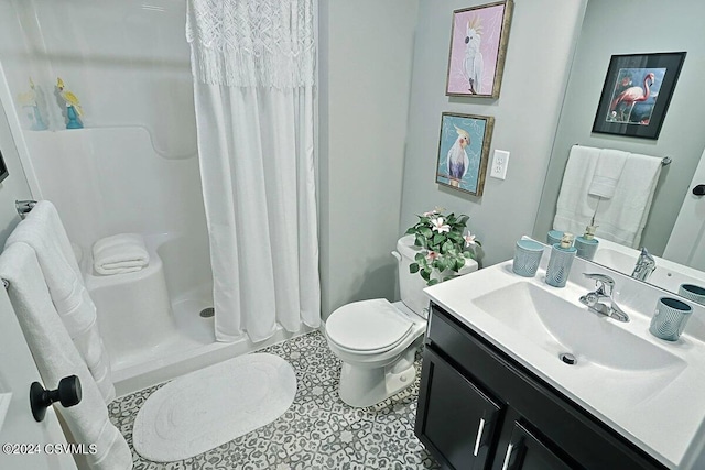 bathroom featuring curtained shower, vanity, and toilet