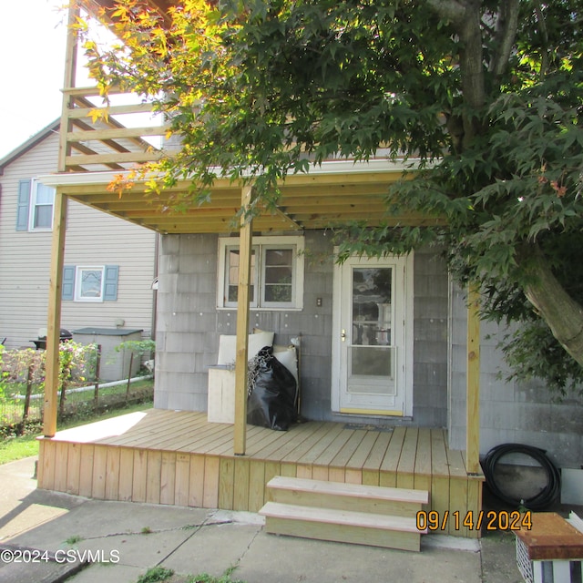 doorway to property featuring a wooden deck