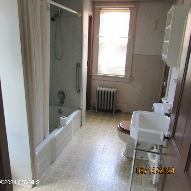 full bathroom with radiator, toilet, shower / tub combo, and sink