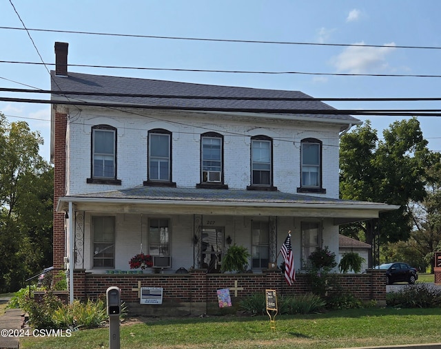 view of front facade featuring a front yard and covered porch