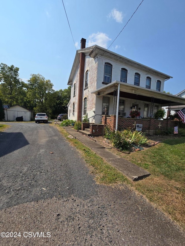 view of property exterior featuring a yard and covered porch