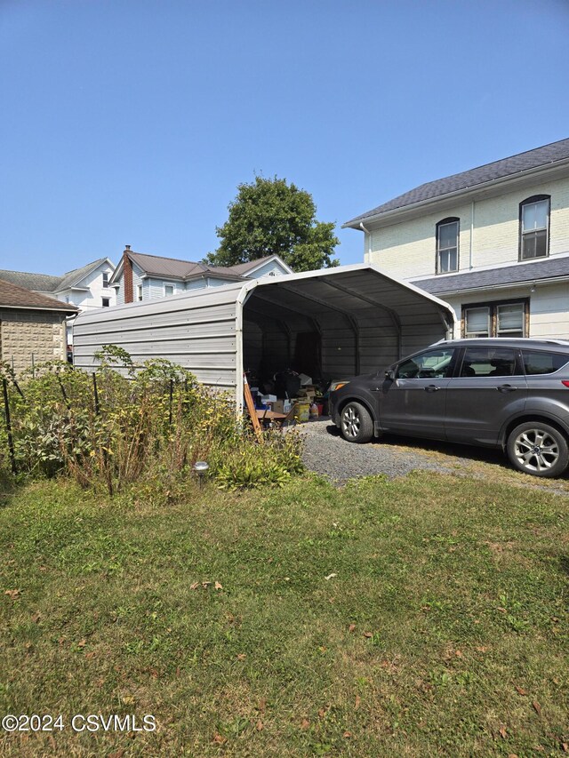 view of side of home featuring a lawn and a carport