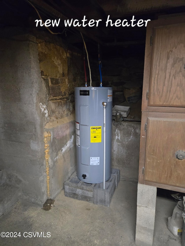 utility room featuring water heater