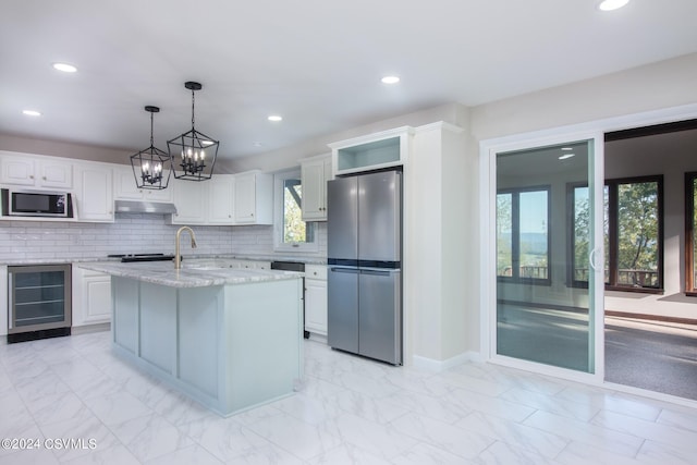 kitchen featuring white cabinets, wine cooler, hanging light fixtures, plenty of natural light, and stainless steel appliances