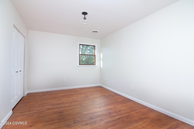 spare room with dark hardwood / wood-style flooring