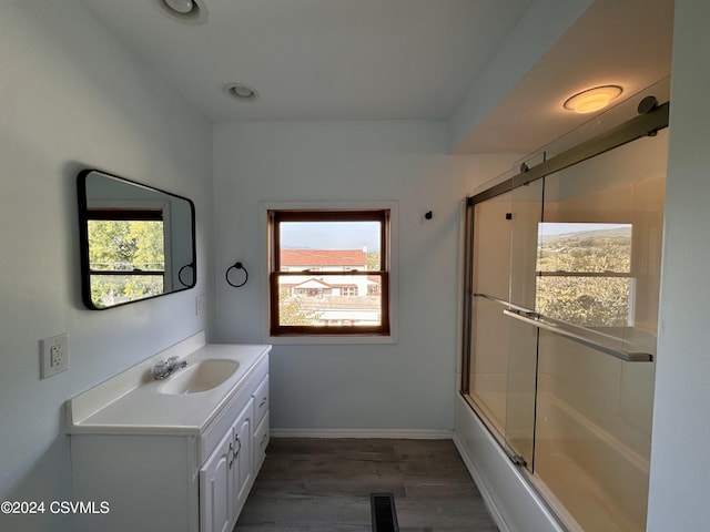 112 Green St, Edwardsville, PA 18704 - full bath with wood finished floors, a healthy amount of sunlight, vanity, and visible vents