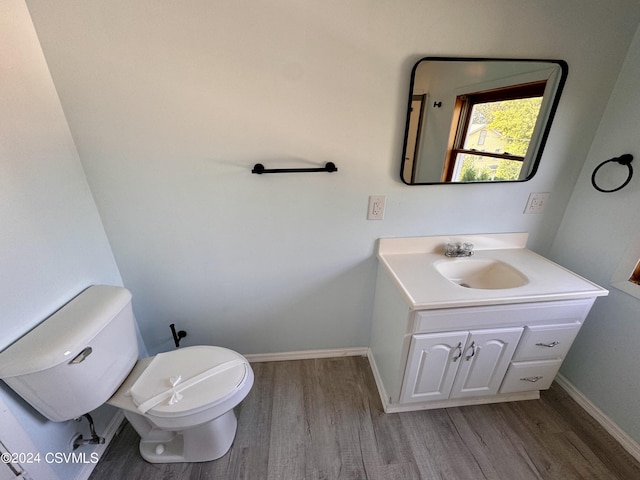 112 Green St, Edwardsville, PA 18704 - half bath featuring baseboards, wood finished floors, toilet, and vanity